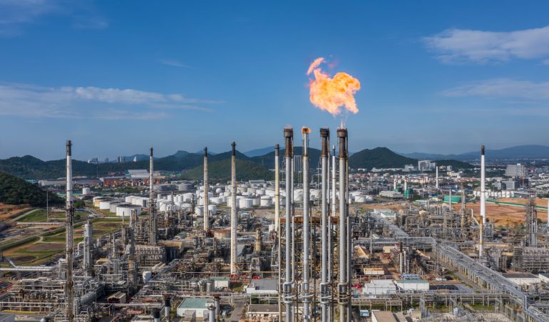 Aerial top view Oil and Gas refinery petrochemical plant industrial with oil and gas storage tank. White oil and gas refinery storage tank. Aerial view oil and gas refinery plant from industrial zone.