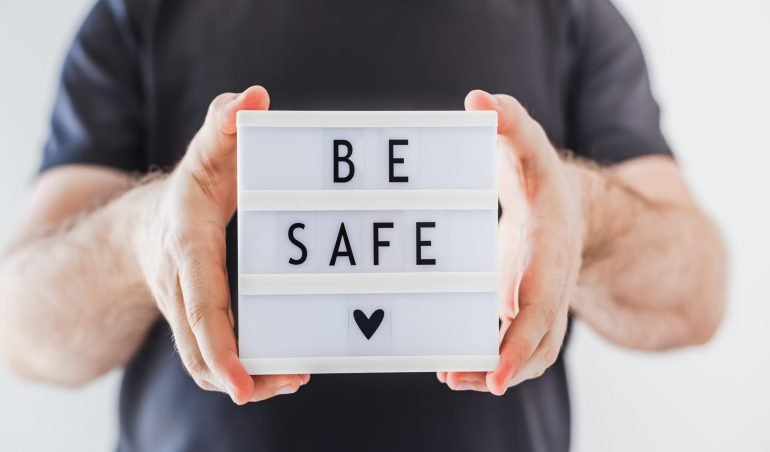 Healthcare and Safety concept. Unrecognised man holding lightbox with text Be safe during coronavirus COVID-19 pandemics